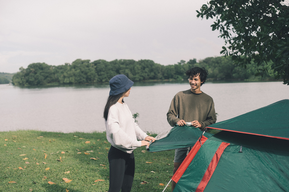 Couple Setting Up Tent in the Field